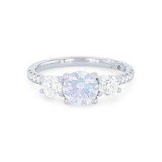 three stone engagement ring in white gold with diamonds on the sides and an oval diamond center