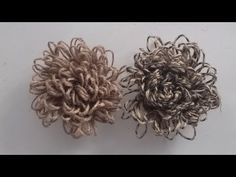 two crocheted flowers sitting next to each other