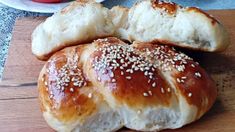 two loaves of bread with sesame seeds on top