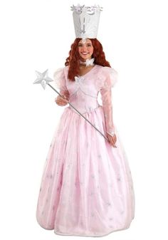 a woman in a pink dress with a crown on her head and holding a wand