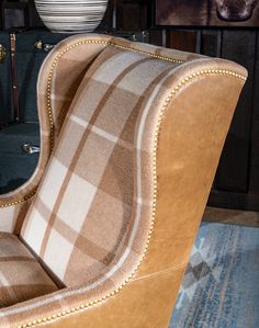 a brown chair sitting on top of a wooden floor