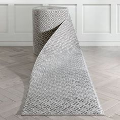 a large white rug on the floor in an empty room