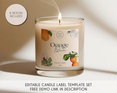 an orange candle is shown with the label in front of it and on the side