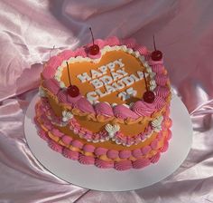 a heart shaped birthday cake with candles on top