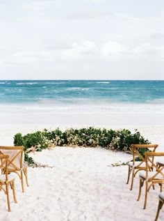 chairs and tables set up on the beach