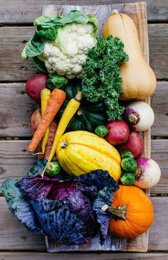 a wooden crate filled with lots of different types of vegetables