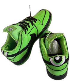 a pair of green sneakers with eyeballs on them