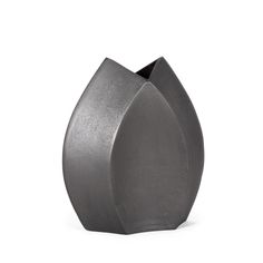 a gray vase sitting on top of a white surface