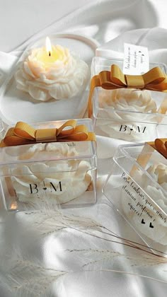 four small clear containers with candles in them