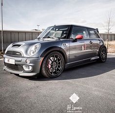 a silver mini cooper parked in a parking lot