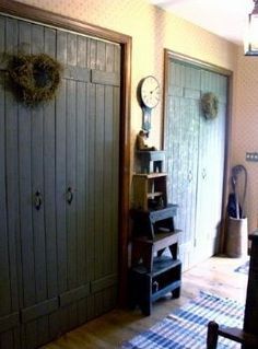 a room with two doors and a clock on the wall next to an open closet