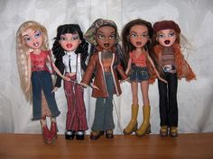 five dolls standing next to each other on a table