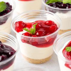 small desserts with cherries and whipped cream in plastic containers on a table top