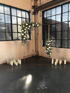 an empty room with candles and flowers on the floor