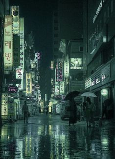 people with umbrellas are walking in the rain on a city street at night time