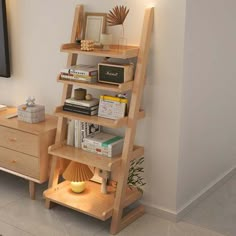 a living room with a television and bookshelf next to a wall mounted flat screen tv