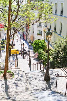 an overhead view of a city street with stairs and trees