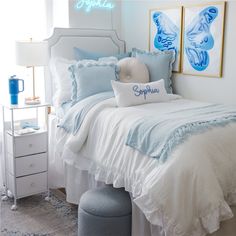 a bedroom with blue and white decor on the walls