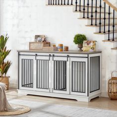 a living room with white furniture and stairs