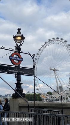 a street light with a ferris wheel in the background