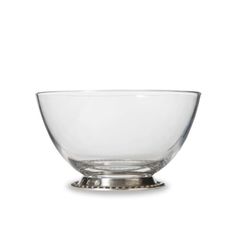 an empty glass bowl sitting on top of a white surface with a silver rim and base