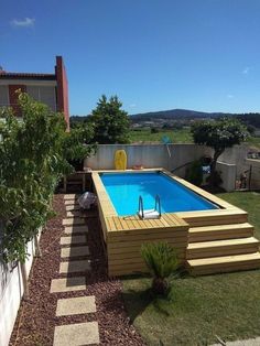 an above ground pool with steps leading up to it and a deck in the middle