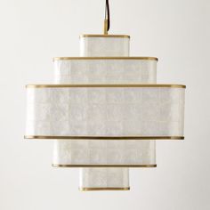 a white and gold chandelier hanging from a ceiling