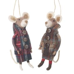 two stuffed mice dressed in coats and boots hanging from strings, one wearing a coat