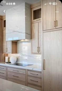 a kitchen with marble counter tops and wooden cabinets