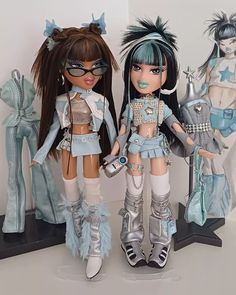 two dolls are standing next to each other