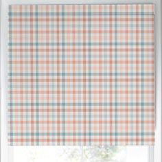 an orange and blue checkered roman blind in front of a window with the blinds closed