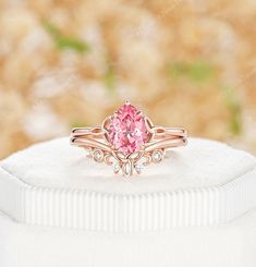 ✦Description At the heart of this stunning rose gold engagement ring set, a mesmerizing 6x8mm Padparadscha Pink Sapphire solitaire main ring takes center stage, capturing the essence of magical transformations.  Complemented by a matching round-cut white moissanite wedding band, the unique celestial moon phase and intricate Celtic knots setting add a touch of celestial allure. Symbolizing eternal love and unity, this set is a poetic ode to the intertwining of romance and cosmic beauty. ✦Main rin Sapphire Bridal Set, Solitaire Ring Designs, Pink Sapphire Band, Rose Gold Engagement Ring Set, Wedding Ring For Her, Sapphire Band, Celtic Knots, Sapphire Solitaire, Pink Sapphire Ring