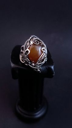 A large ring with ginger chalcedony is woven using the wire wrap technique. The ring is adjustable in size and can be adjusted to suit yours. To do this, select the size that suits you best from the menu. If you would like to purchase a set, I can offer you a bracelet https://www.etsy.com/listing/1664295369/adjustable-wire-wrapped-chalcedony?ref=listings_manager_grid ATTENTION: Please note that In reality colors of jewelry may look slightly different than colors in photos on your screen. It depends on your monitor calibration and its color rendering. HOW TO CARE: Over time, the metal may darken slightly. It depends on the degree of contamination of the surface of the jewelry. It is very easy to clean metal with cloths for jewelry. Or rub thoroughly with a toothbrush with toothpaste. After Adjustable Amber Wire Wrapped Jewelry, Bohemian Wire Wrapped Chalcedony Jewelry, Bohemian Chalcedony Wire Wrapped Jewelry, Handmade Adjustable Moonstone Ring, Handmade Adjustable Unique Moonstone Ring, Unique Handmade Adjustable Moonstone Ring, Handmade Agate Moonstone Ring Gift, Handmade Bohemian Amber Rings, Unique Handmade Freeform Ring