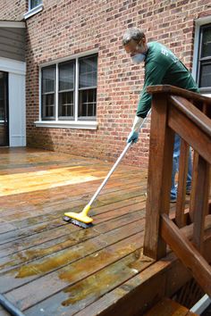 a man is cleaning the deck with a mop