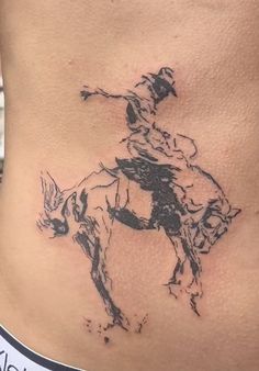 a woman with a cowboy tattoo on her stomach