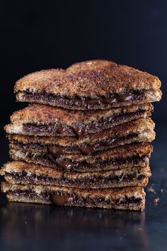 a stack of chocolate filled pancakes on top of a table