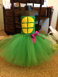 a green tutu with a yellow turtle on it