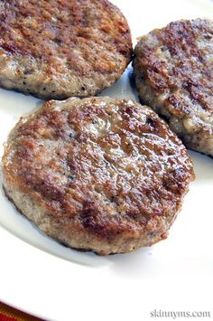 two hamburger patties sitting on top of a white plate