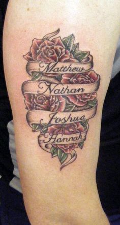 a woman's arm with an old fashioned rose and ribbon tattoo design on it