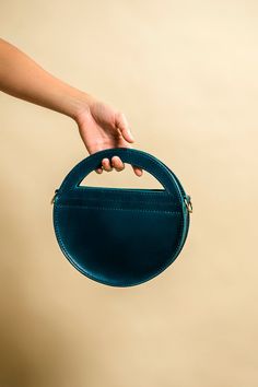 This is my newest design called the Hali Bag. It gets its name from the Greek meaning "the sea". Its made from Buttero Veg Tan Leather by Conceria Walpier, some of the finest Italian leather produced. It offers two ways of wear, from the unique half moon handle or a detachable and adjustable strap. Its roughly 10 x 9 1/2 x 2 and has a strap thats over 50 inches long, giving you lots of room to wear it as a crossbody or over the shoulder. Each one is crafted by hand from start to finish, using Ri Leather Bags With Round Handle For Gifts, Simple Leather Bag, Greek Meaning, Hand Candy, Unique Handbags, Stylish Purse, Luxury Purses, Sling Bags, Veg Tan Leather