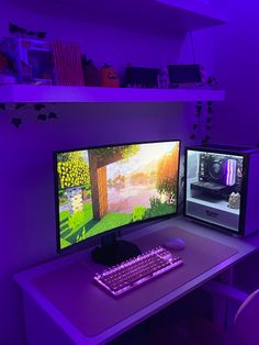 two computer monitors sitting next to each other on top of a desk in front of a purple light