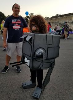 a man standing next to a woman in a costume