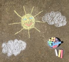 a child's drawing on the ground with chalk and crayons