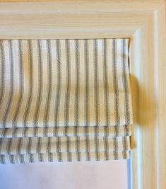 a close up of a window with a striped fabric on it's valance