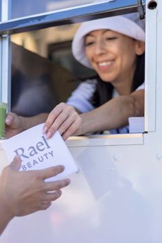 A person handing a Rael Beauty product out of a mobile store window Shopper Bags, Free Product, The Grove, Shopper Bag, Qr Code