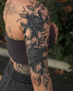 a woman with a flower tattoo on her arm