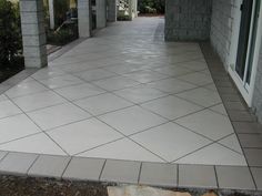 a white tiled walkway in front of a house