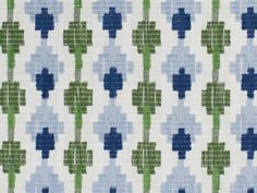 a blue and green pattern on fabric with small crosses in the center, all over it