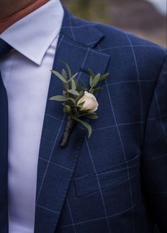 a man in a suit with a boutonniere on it's lapel