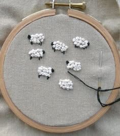 a close up of a embroidery with sheep on it